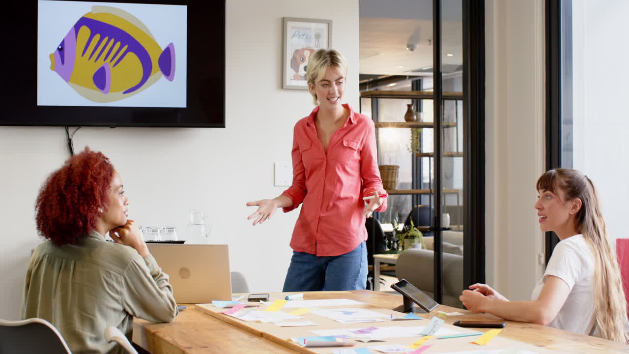 Presenting creative ideas, woman standing in meeting room with colleagues and laptop