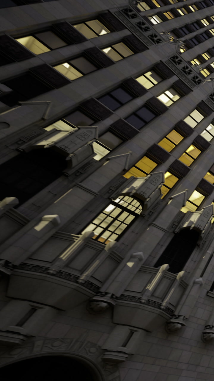 Building with lighted windows in a city at dusk
