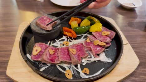 sizzling beef slices on a hot stone