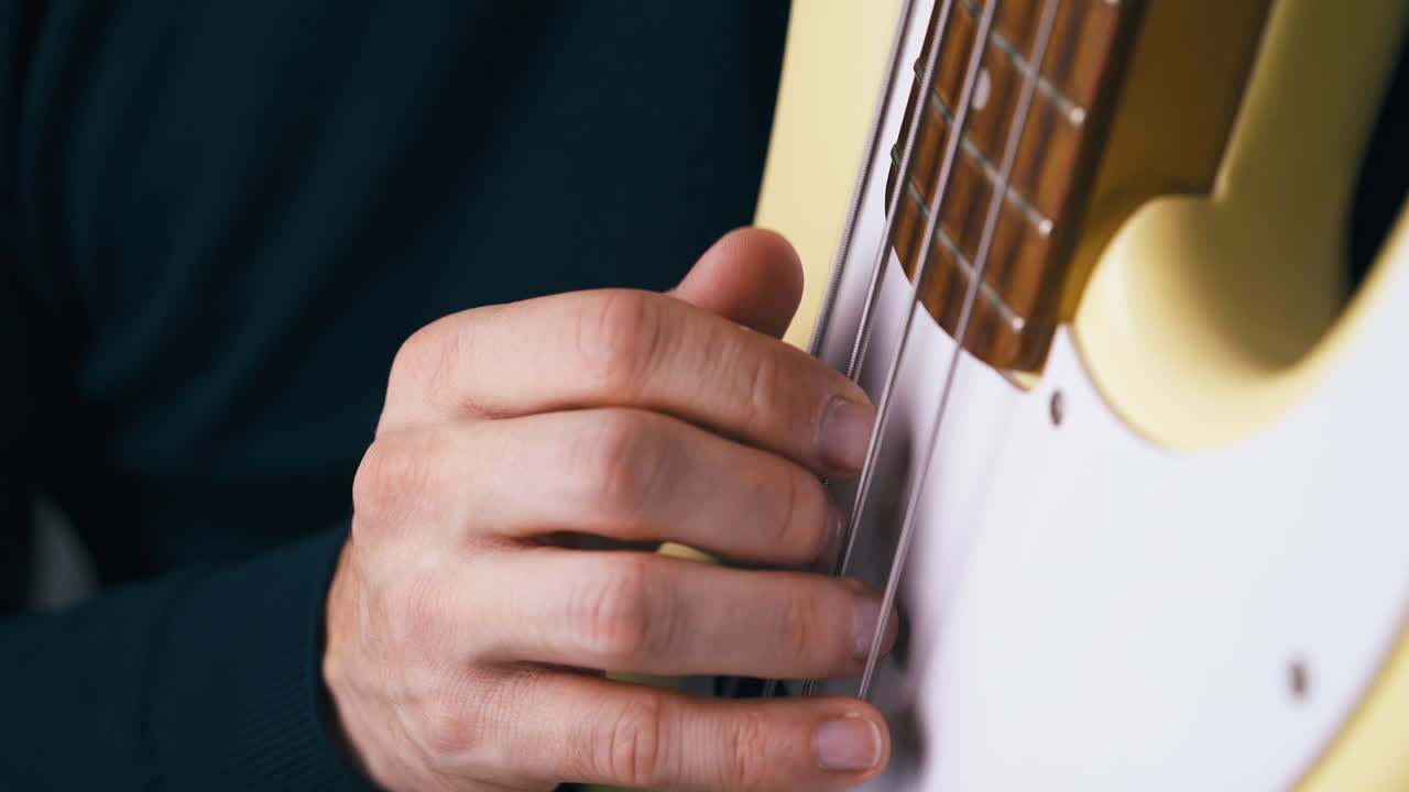 músico profesional toca el bajo en posición vertical