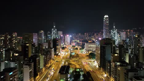 a breathtaking aerial view captures the vibrant city lights of hong kong at night, showcasing towering skyscrapers, busy roads, and the energy of urban life.