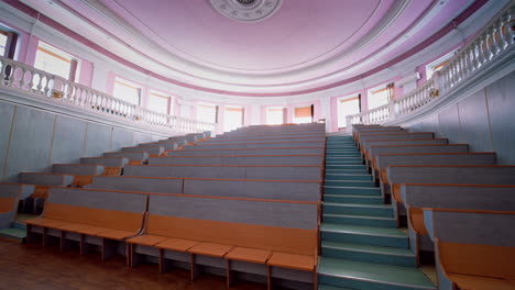 beautiful conference hall with empty seats. modern auditorium with wooden desks for lectures. spacious university classroom without people.
