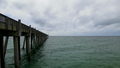 Wooden-Pier-in-Atlantic-Ocean-in-Pensacola,-Florida---Epic-Aerial-Drone-Shot