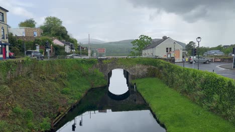 stone arch bridge crosses river side canal in green killaloe ireland