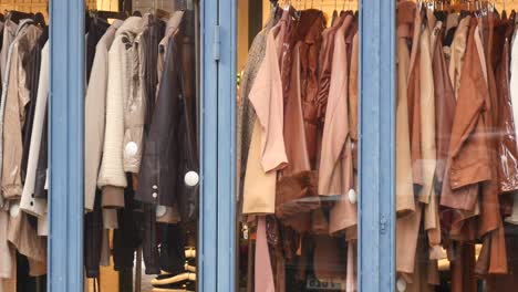 window display of clothing store with coats and jackets