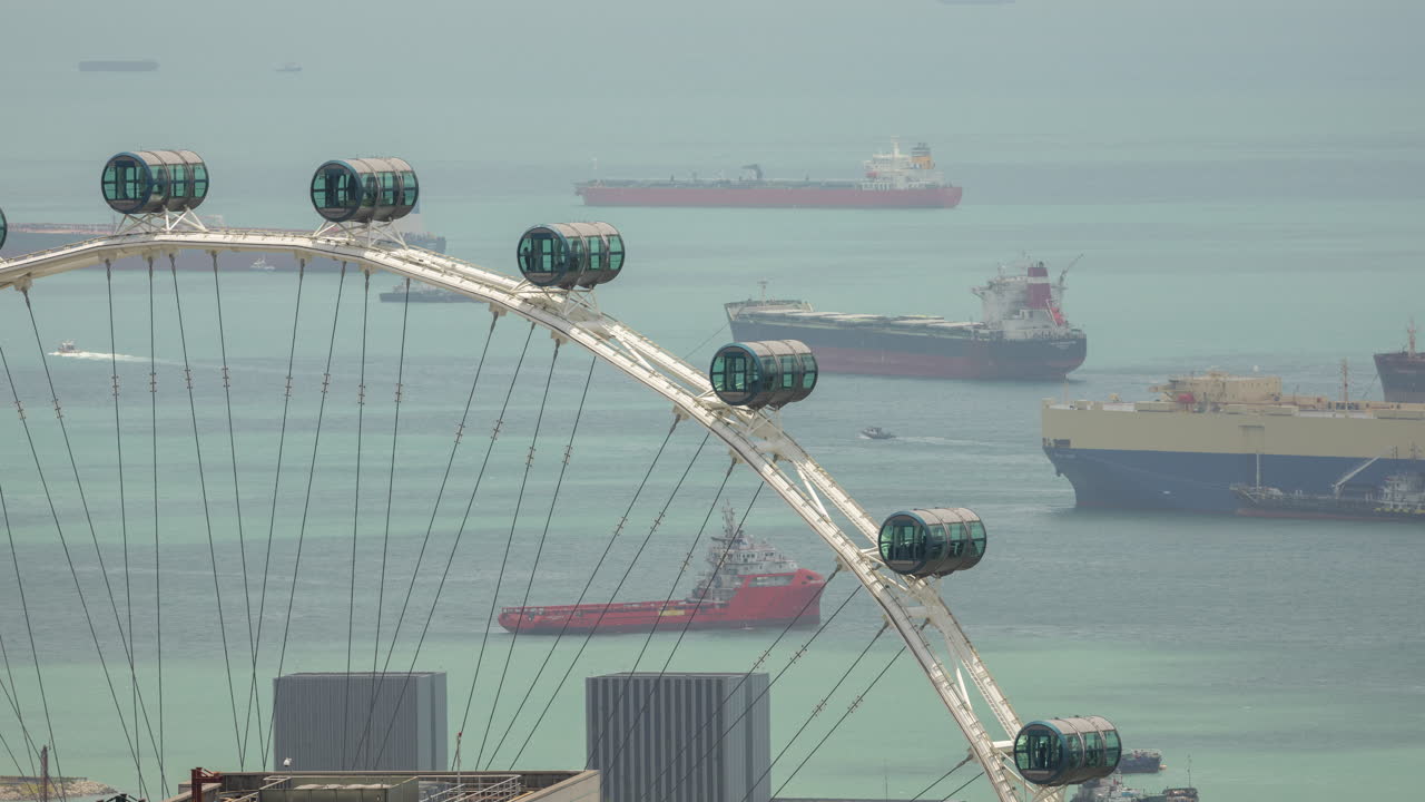 container ships and ferris wheel in singapore