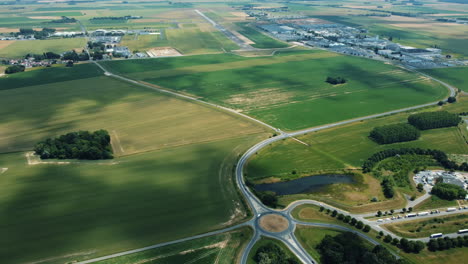 aerial view of agricultural land, airport, and surrounding infrastructure