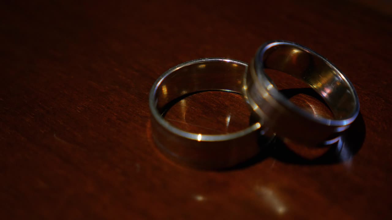 Wedding rings on the table. Reflected in the table of the Rings