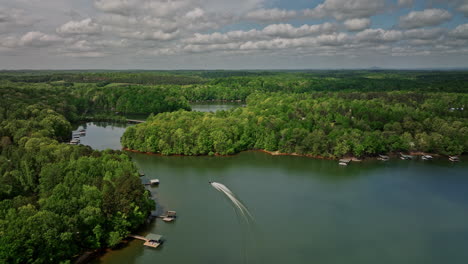 lake hartwell georgia aerial v9 drone flyover gumlog lakeside homes along the shoreline capturing beautiful landscape with jet ski riding across meandering lake - shot with mavic 3 cine - april 2022