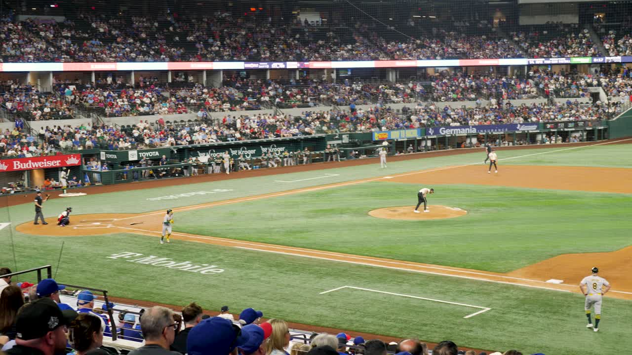 Slow motion landscape of baseball professional player hitting ball in Stadium Dallas Texas Arlington Globe Life Field USA America game team league sports crowd