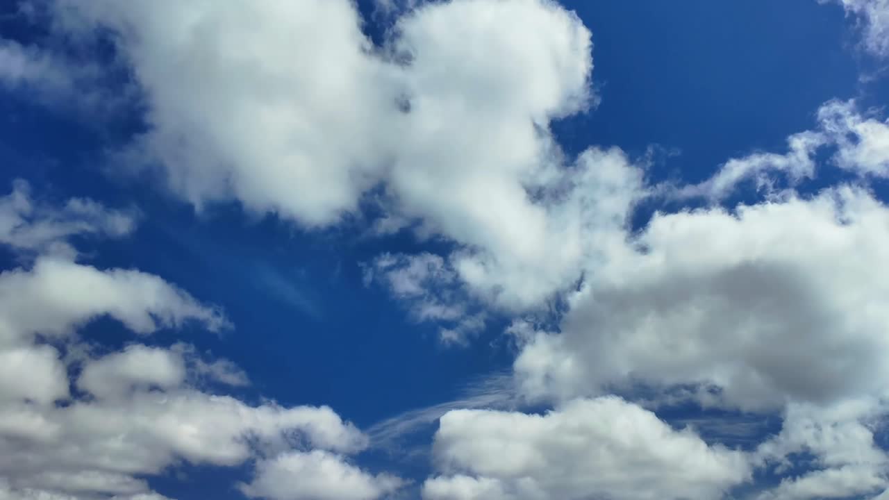 Deep blue sky and white clouds timelapse. 4K UHD cloudscape background