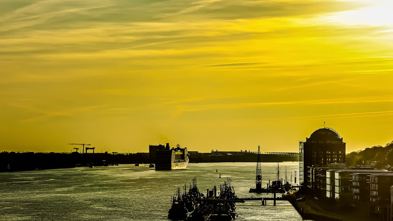 Video in timelapse of queen Mary 2 leaving the harbour in Hamburg,Germany 2013. Golden hue of the setting sun in Germany.