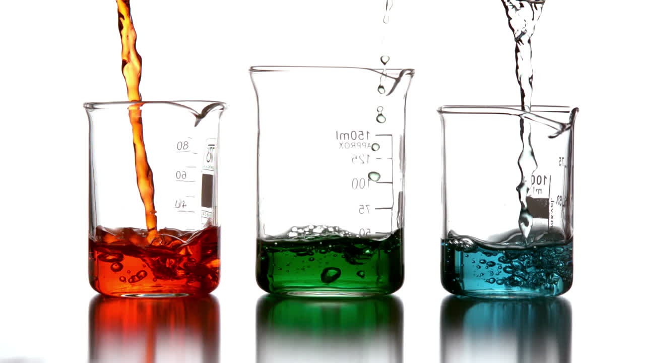 Colored chemicals pouring into beakers