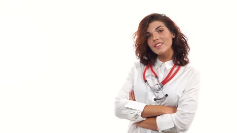 Young-female-doctor-walking-in,-smiling-friendly,-crossing-arms-and-looking-at-camera.-Portrait-of-young-medical-professional-with-stethoscope-and-lab-coat-isolated-on-white-background