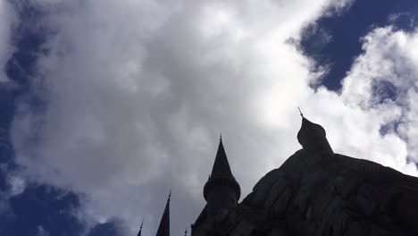 timelapse clouds moving above a castle on a sunny day.