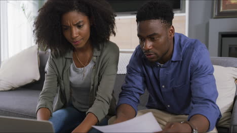 a young couple looking stressed out while doing