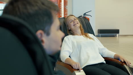 young woman enjoying massage in special arm-chair