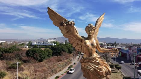 golden angel sculpture in jiutepec, morelos, with a clear sunny sky backdrop