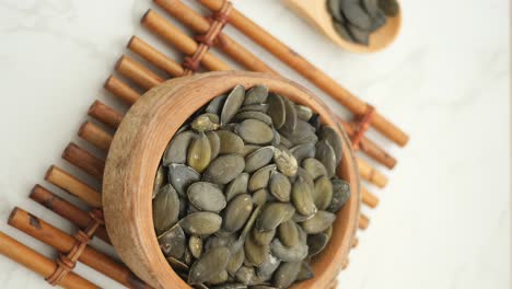 pumpkin seeds in wooden bowl