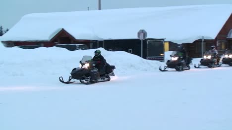 Snowplows-move-through-deep-snow-in-a-small-town