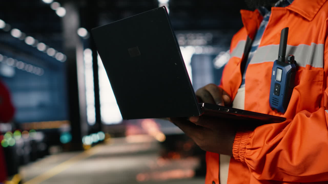 African american supervisor directing production tasks using laptop