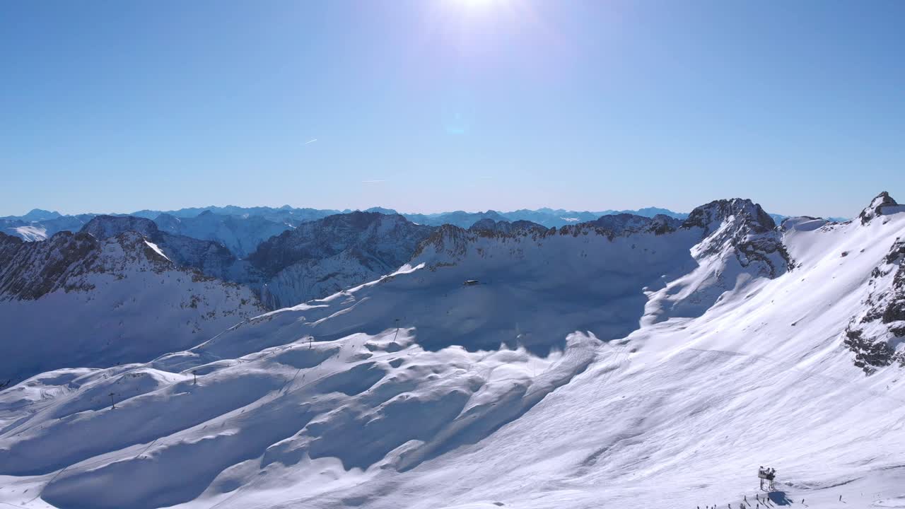 Wetterstein Mountains in a sunny day with some skiers in the background in the Zugspitze ski area