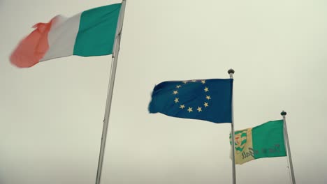 irish flag blowing in the wind on a breezy day at iconic ireland links golf course