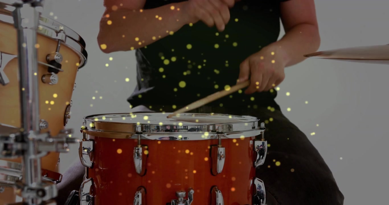 Music drummer starting poised, playing snare, crossing hands, tapping cymbal gold particles overlay