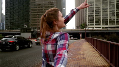 young woman showing great view of modern city skyscrapers. follow me concept