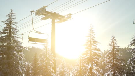 empty ski lift. chairlift silhouette on high mountain over the forest at sunset