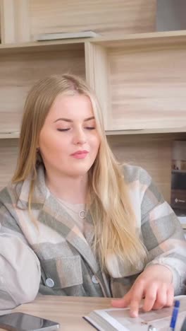 woman with blonde hair wearing a plaid jacket