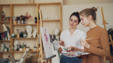 women learning to paint in an art studio