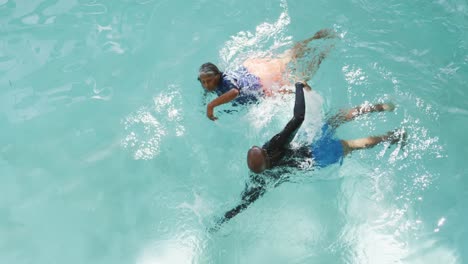 video of happy senior african american couple swimming