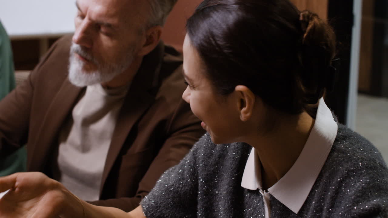 Professionals engaging in a lively business discussion and note-taking