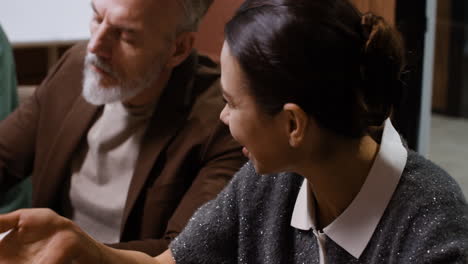 professionals engaging in a lively business discussion and note-taking