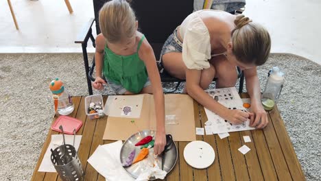 mother and daughter crafting food decorations