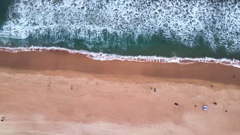 Aerial-Top-View-of-a-few-people-enjoying-beach-time-in-the-south-of-Brazil