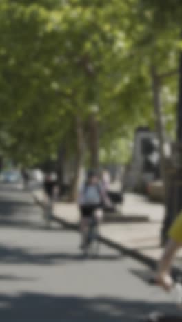 Defocused Vertical Video Pedestrians Cyclists Busy Traffic Commuting The Embankment