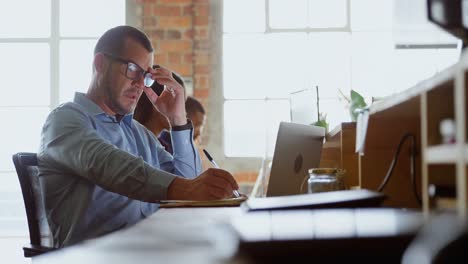 Executive-working-at-desk-in-office-4k