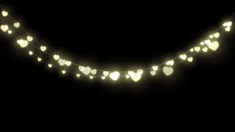 digital animation of decorative heart shaped fairy lights hanging against black background