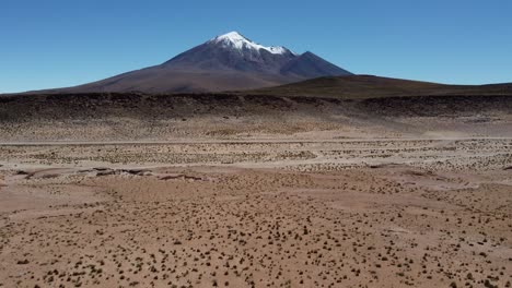 snow capped mountain peak in bolivia seen from high desert altiplano