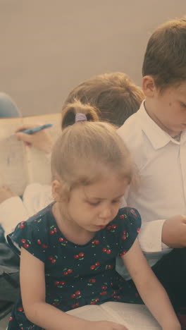 exciting children in classic dressing prepare for difficult exams reading boring textbooks outdoors close view