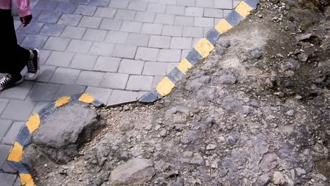 Yellow-and-black-barrier-bars-on-the-edge-of-the-road-indicate-caution-when-traveling