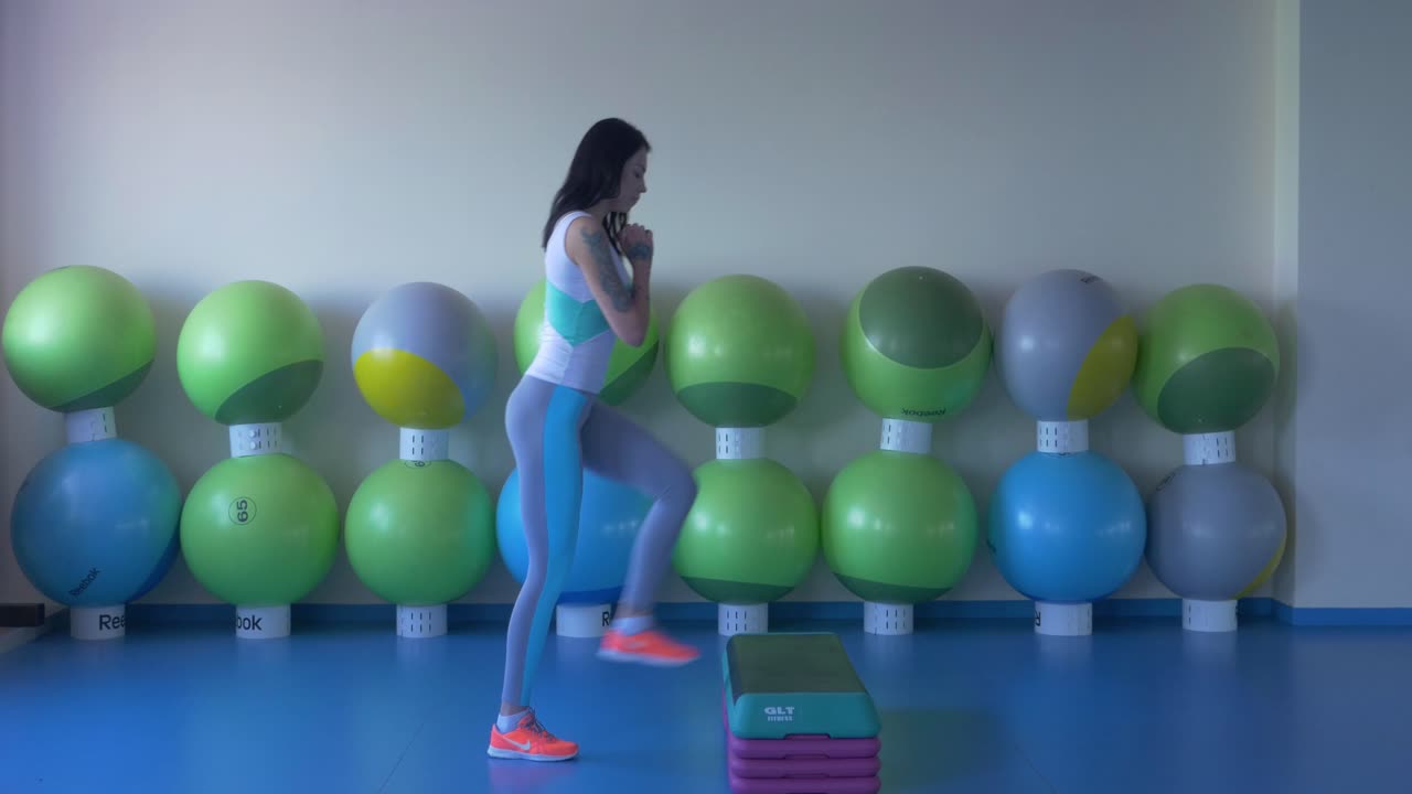 Woman Performing Step-Ups in a Gym