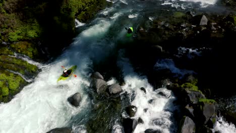 aerial view of whitewater kayaker running class iv rapids on the mill creek section of the rogue river in southern oregon