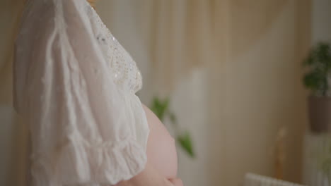 close-up of pregnant woman's belly in expectation