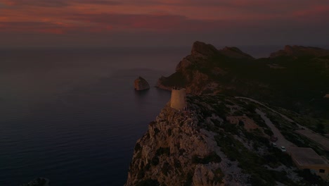 sunset at es colomer island albercutx watchtower, cap formentor, mallorca, spain