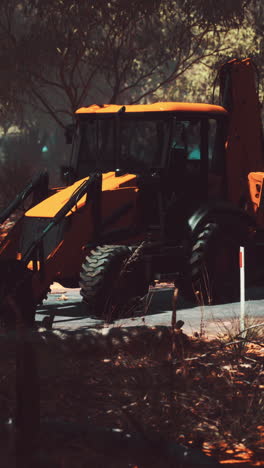 yellow backhoe in a forest
