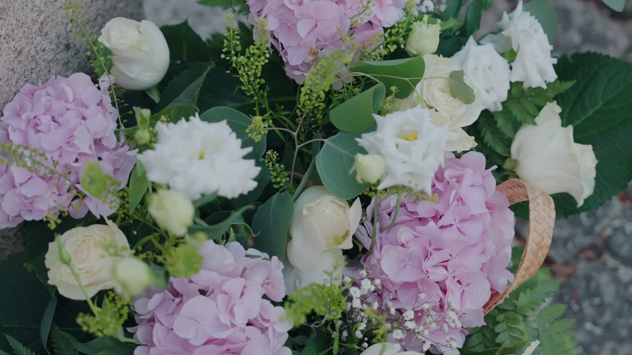 Pastel wedding flower arrangement with roses and hydrangea closeup