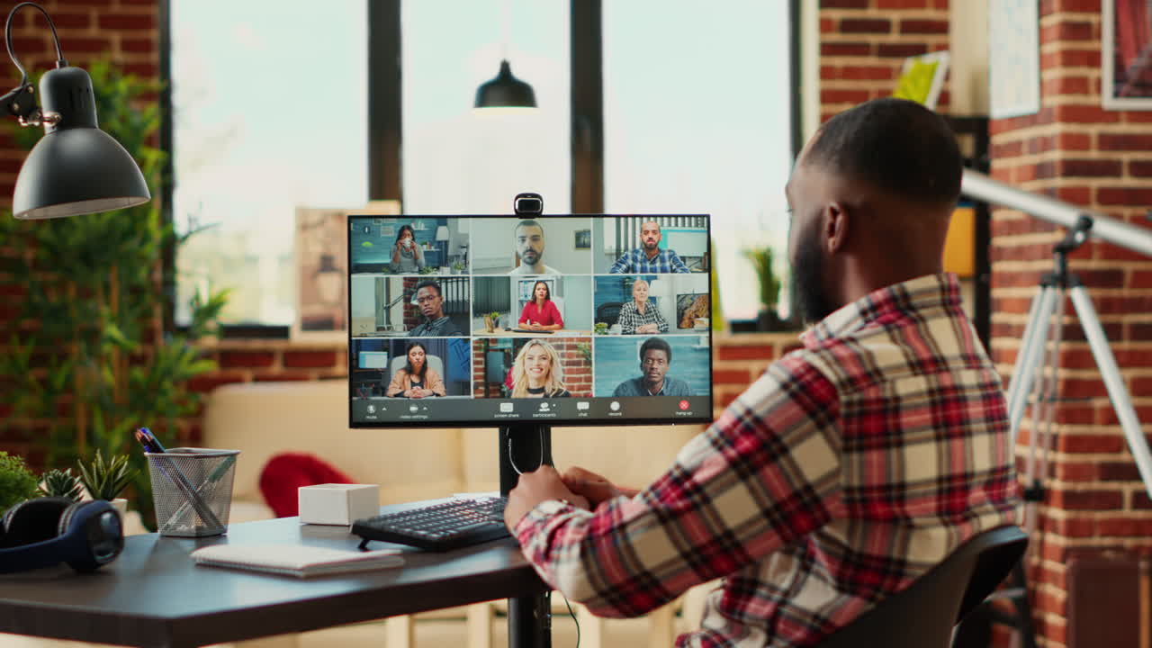 Man attending online meeting at his home office